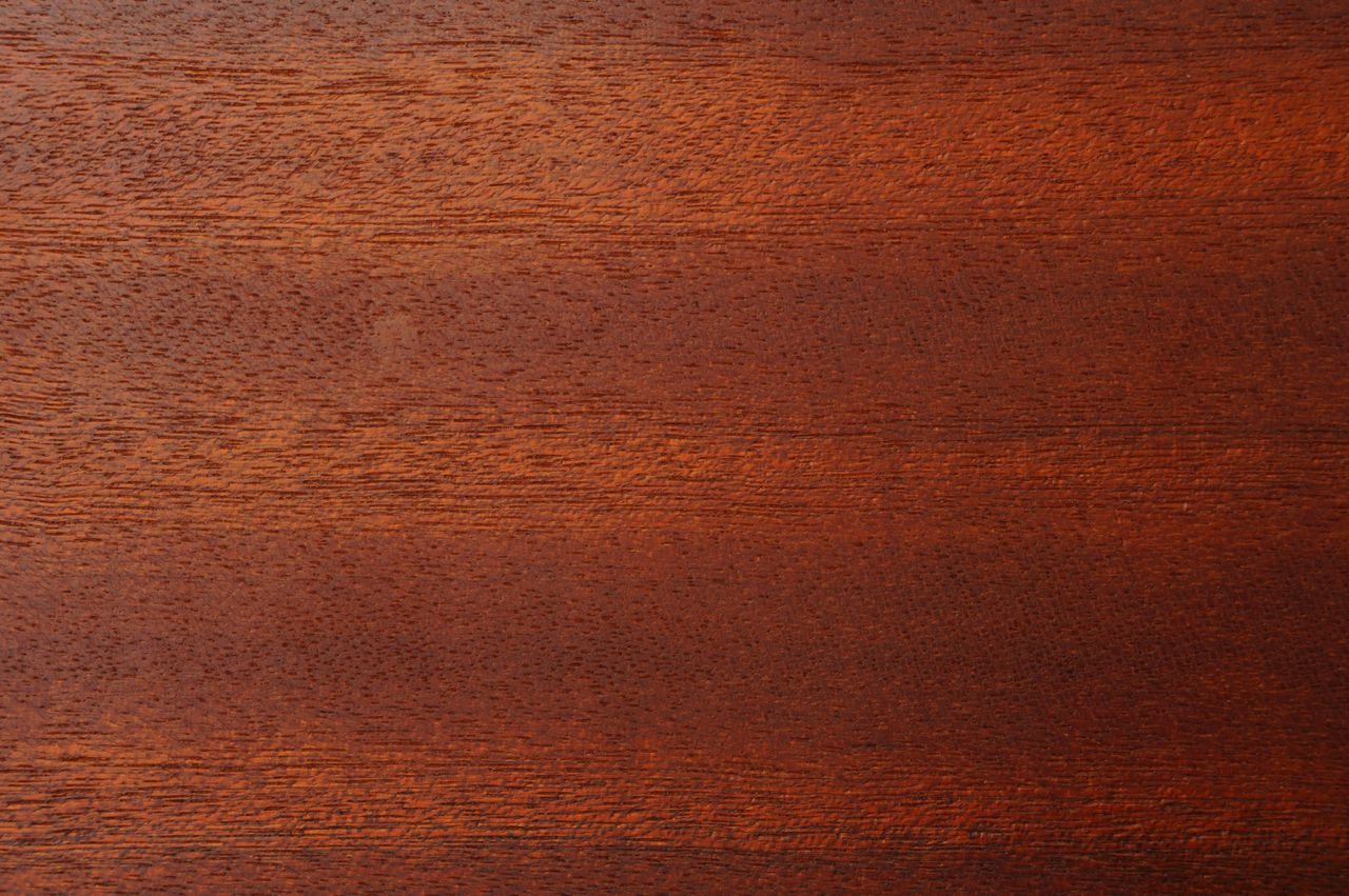 Close-up image of a rich brown wood texture, perfect for backgrounds and design.